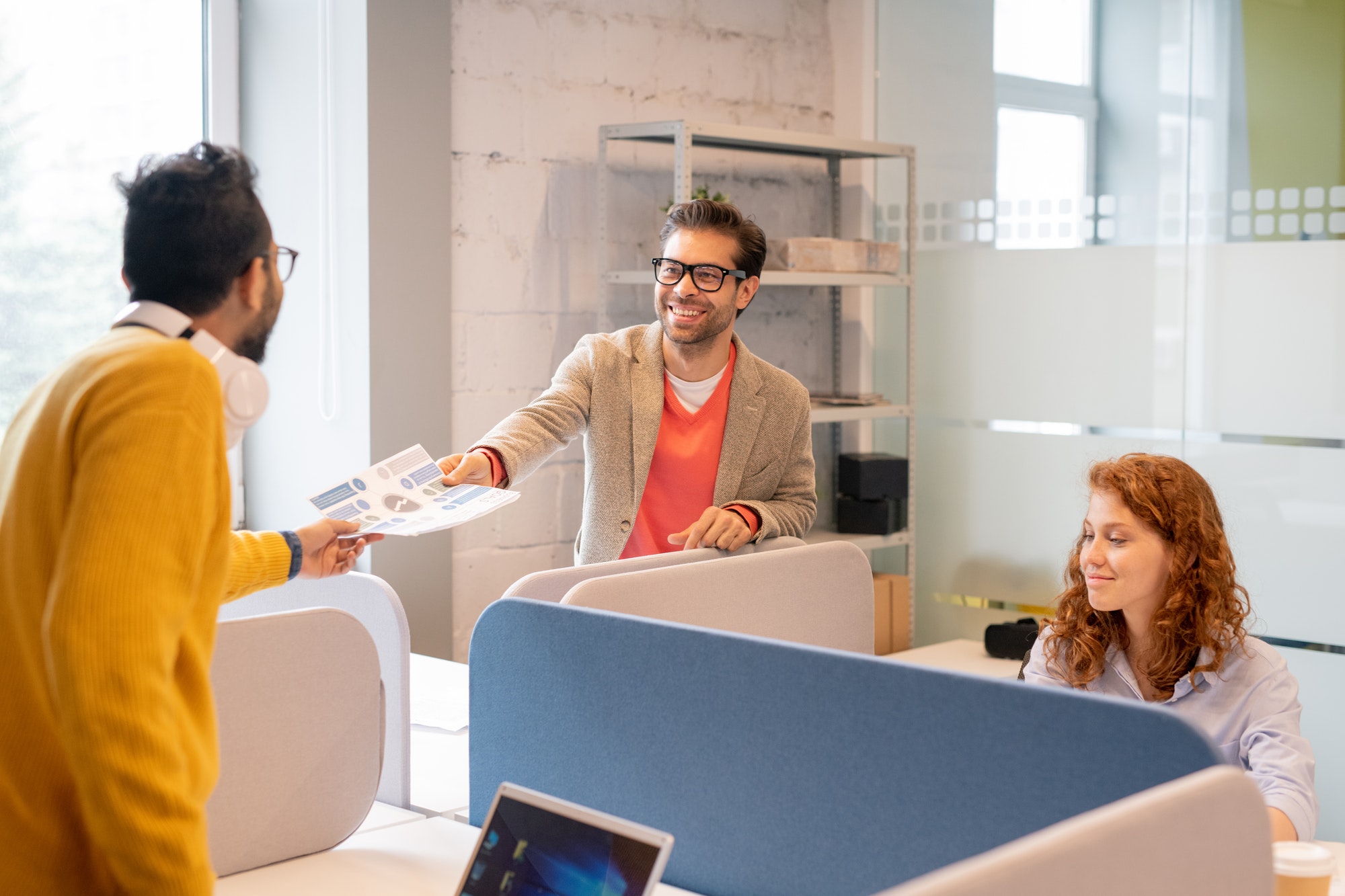 Employees working on financial report in office